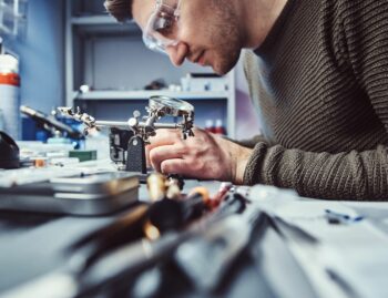 a male engineer working on a machine to create a product